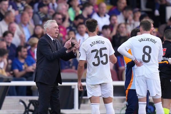Real Madrid's head coach Carlo Ancelotti, left, gives instructions during the Spanish La Liga soccer match between Barcelona and Real Madrid at the Lluis Companys Olympic Stadium in Barcelona, Spain, Sunday, May 11, 2025. (AP Photo/Jose Breton)