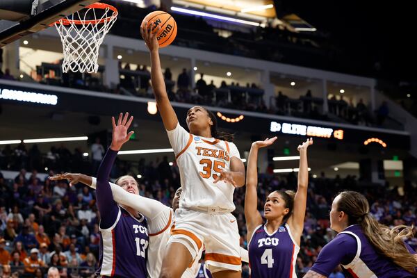 Texas forward Madison Booker (35) lays in a basket against TCU during the second half in the Elite Eight of the NCAA college basketball tournament, Monday, March 31, 2025, in Birmingham, Ala. (AP Photo/Butch Dill)