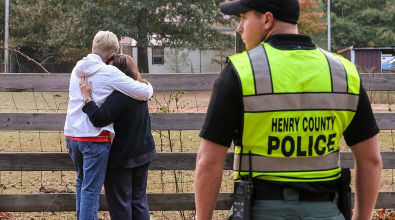 Distraught family and friends came to the scene where three people were killed and one person was critically injured Thursday, Oct. 27, 2016 in a quadruple shooting in Henry County. JOHN SPINK /JSPINK@AJC.COM