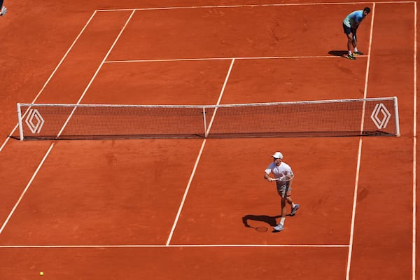 Tommy Paul of the U.S. reacts winning a point to Australia's Alexei Popyrin, top right, during their fourth round match of the French Tennis Open, at the Roland-Garros stadium, in Paris, Sunday, June 1 2025. (AP Photo/Lindsey Wasson)