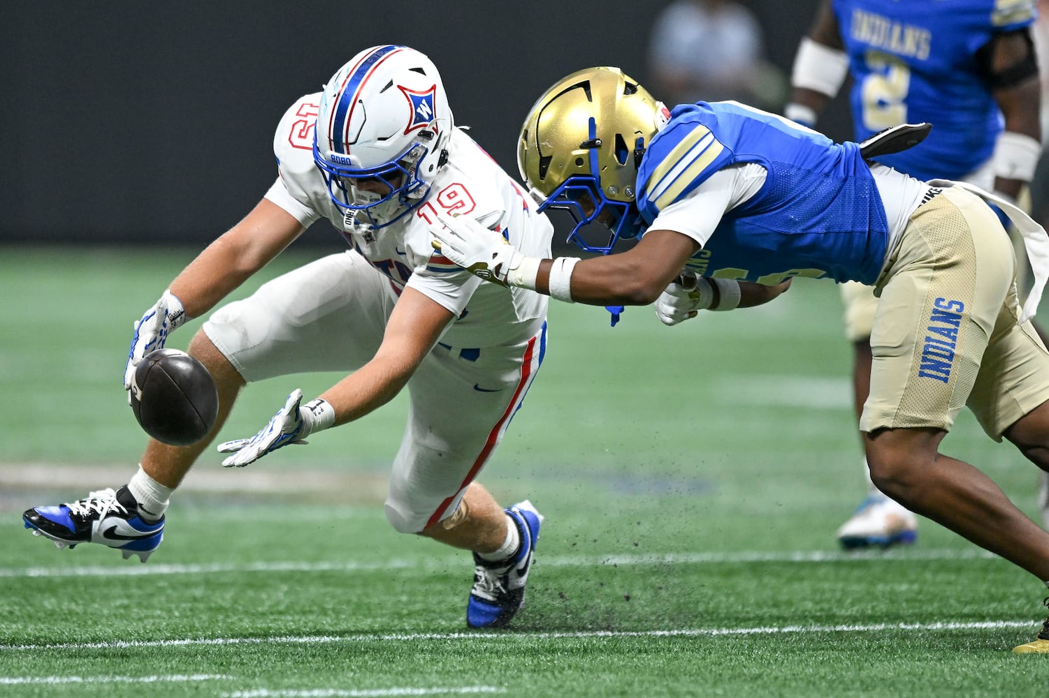 Walton tight end Jude Cascone (19) and McEachern’s Casey Barner (6) fight for possession of the ball during the first half of the Corky Kell Classic football game Saturday, August 16, 2025 at the Mercedes-Benz Stadium. (Daniel Varnado/For the Atlanta Journal-Constitution)