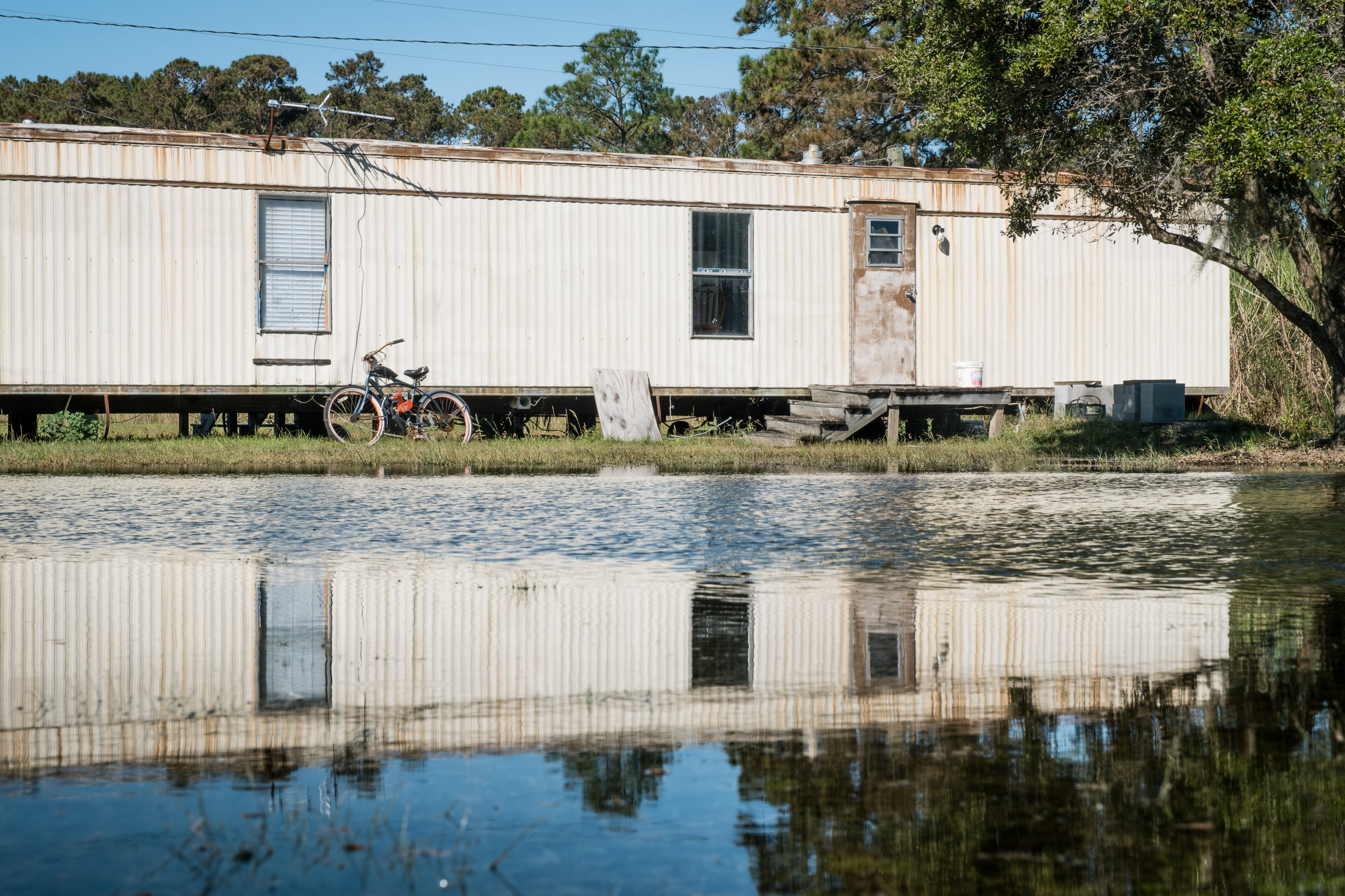 Rising seawater from a king tide encroaches on a home in the Hogg Hummock community on Sapelo Island. (Justin Taylor for the AJC)