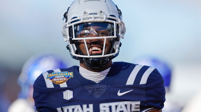 Utah State wide receiver Jalen Royals (1) celebrates after a 35 yard touchdown reception against Georgia State in the first half of the Famous Idaho Potato Bowl NCAA college football game, Saturday, Dec. 23, 2023, in Boise, Idaho. Georgia State won 45-22. (AP Photo/Steve Conner)