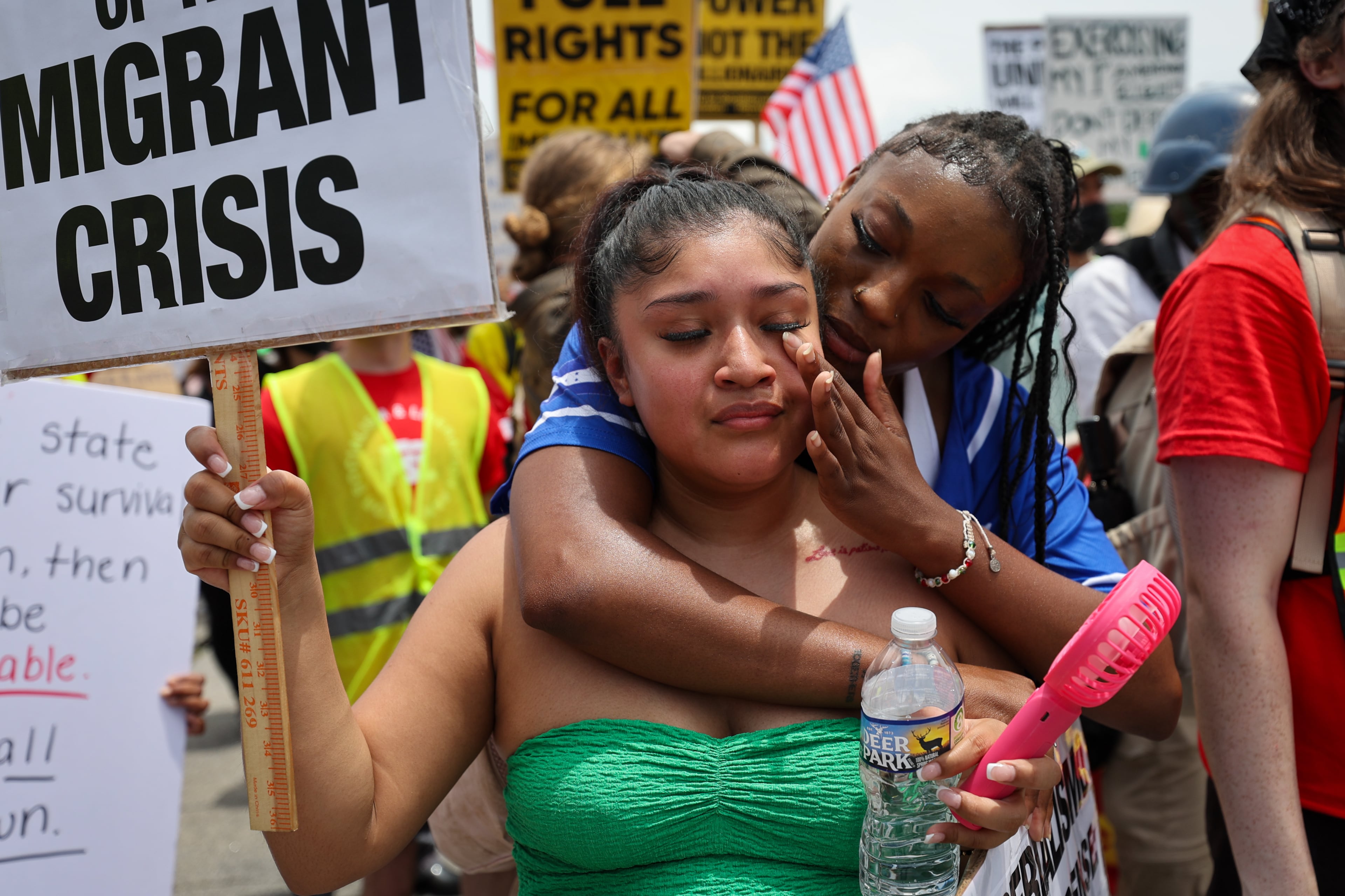 One protesters consoles another at the immigration protest at Chamble Tucker Road in Decatur on Saturday, June 14, 2025. (Arvin Temkar/AJC)