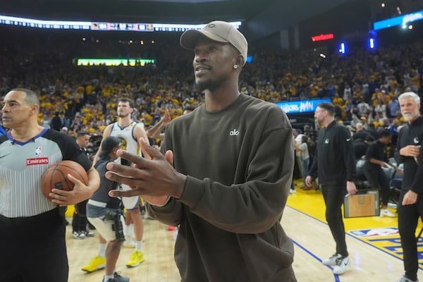 Injured Golden State Warriors forward Jimmy Butler III walks on the floor after Game 3 of an NBA basketball first-round playoff series against the Houston Rockets in San Francisco, Saturday, April 26, 2025. (AP Photo/Jeff Chiu)