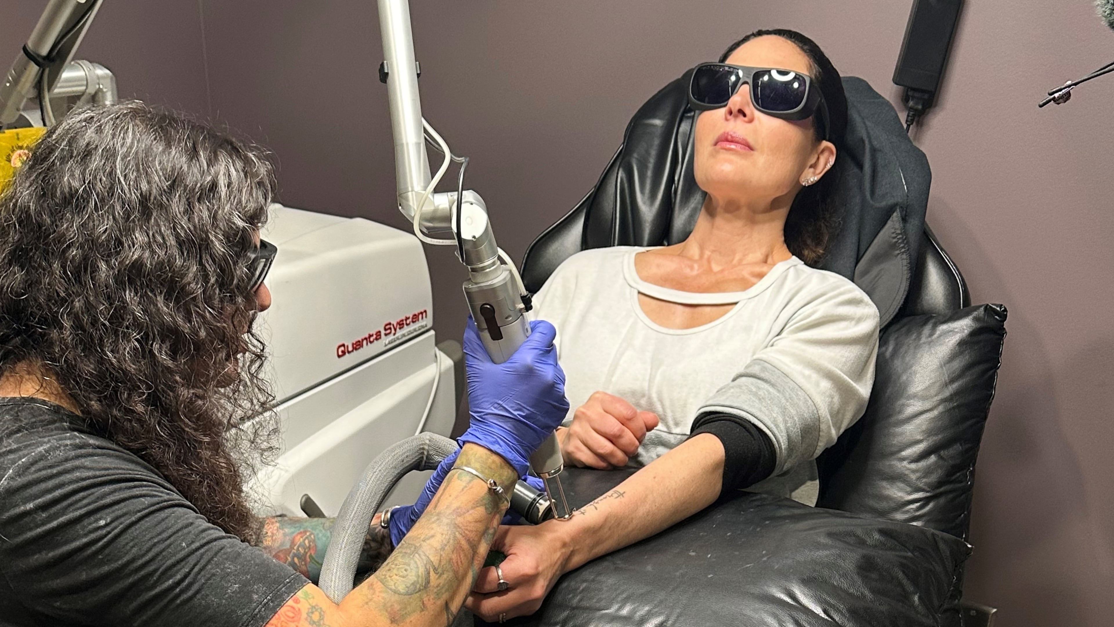Tracy Herrmann has one of her tattoos removed by Chroma Tattoo Studio Laser Tattoo Removal owner Jaime Howard on Nov. 19, 2025, in West Bloomfield, Mich. (AP Photo/Corey Williams)
