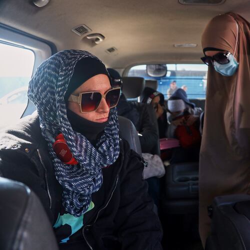 Family members of suspected Islamic State militants who are Australian nationals board a van heading to the airport in Damascus during the first repatriation operation of the year, at Roj Camp in eastern Syria, Monday, Feb. 16, 2026. Thirty-four Australian citizens from 11 families departed the camp. (AP Photo/Baderkhan Ahmad)