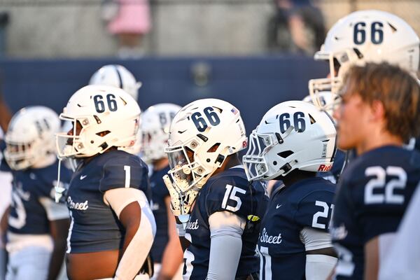 Marietta players wear helmets that feature number “66” in recognizing Lemon Street’s 1966 state championship during their game Friday, Sept. 19, 2025 at Northcutt Stadium in Marietta. (Daniel Varnado/For the Atlanta Journal-Constitution)