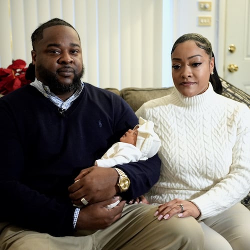 Leon and Mercedes Wells hold their newborn daughter Alena at their home in the Chicago suburb of Dolton, Ill. on Friday, Nov. 28, 2025. (AP Photo/Mark Vancleave)