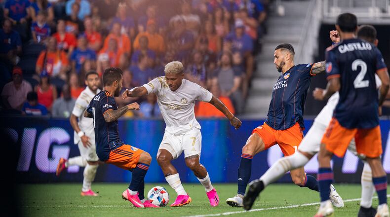 Atlanta United forward Josef Martinez (7) dribbles the ball through a gauntlet of FC Cincinnati defenders Wednesday, July 21, 2021, at TQL Stadium in Cincinnati. (Jacob Gonzalez/Atlanta United)