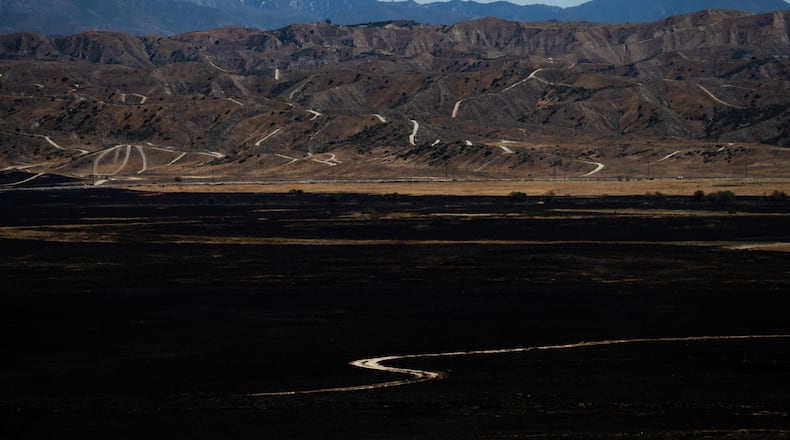 A charred field is seen after the Springs Fire in Moreno Valley, Calif., Saturday, April 4, 2026. (AP Photo/Jae C. Hong)