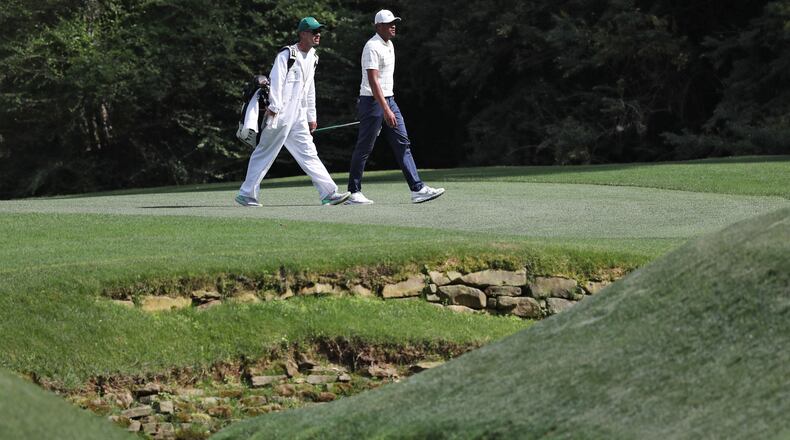 Tony Finau crosses Rae's Creek on No. 13 during the third round of the Masters Tournament Saturday, April 13, 2019, at Augusta National Golf Club in Augusta. Jason Getz / Special to the AJC