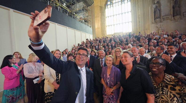 Andy Burnham with colleagues from the Parliamentary Labour Party in Westminster Hall at the Houses of Parliament in central London, as he returns to the House of Commons to take up his seat after winning the Makerfield by-election, Monday June 22, 2026. (Yui Mok/PA via AP)