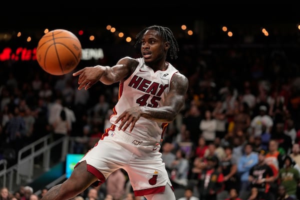 Miami Heat guard Davion Mitchell (45) passes the ball in overtime of an NBA play-in tournament basketball game against the Atlanta Hawks, Friday, April 18, 2025, in Atlanta. (AP Photo/Brynn Anderson)