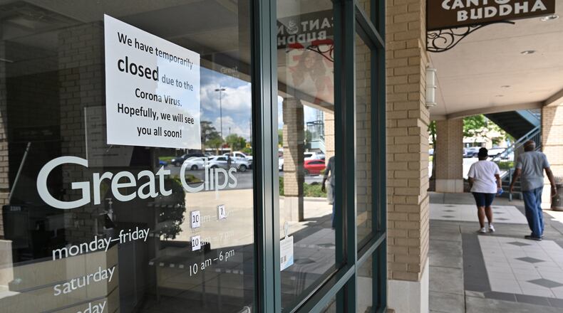 At the Great Clips salon at the Peach Shopping Center in Buckhead on Tuesday, April 21, 2020, a note states that the business is temporarily closed under a stay-at-home mandate issued amid the COVID pandemic. But Gov. Brian Kemp is allowing salons and some other businesses to resume operations by Friday if they comply with social-distancing requirements and other safety standards. (Hyosub Shin / Hyosub.Shin@ajc.com)