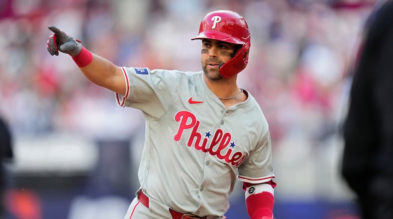 Philadelphia Phillies' Whit Merrifield celebrates after hitting a 3-run home run against the New York Mets during the fourth inning of a London Series baseball game in London, Saturday, June 8, 2024. (AP Photo/Kirsty Wigglesworth)