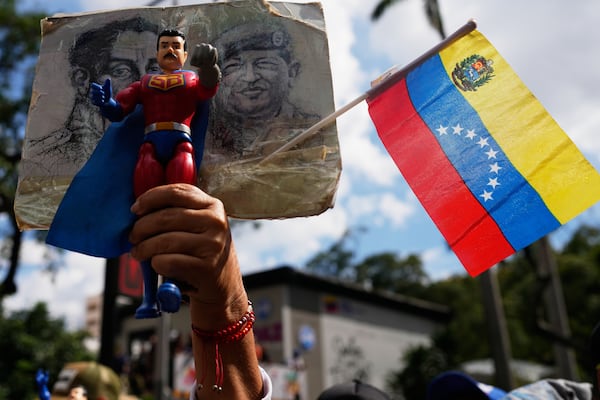 A government supporter holds an action figure of Super Bigote during a protest demanding the release of President Nicolas Maduro, who was captured by U.S. forces, in Caracas, Venezuela, Sunday, Jan. 4, 2026. (Ariana Cubillos/Ap)