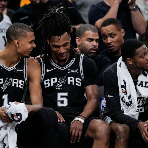 San Antonio Spurs' Victor Wembanyama (1) speaks with Stephon Castle (5) on the bench in the second half of Game 6 in the Western Conference finals NBA basketball playoffs series, Thursday, May 28, 2026, in San Antonio. (AP Photo/David J. Phillip)
