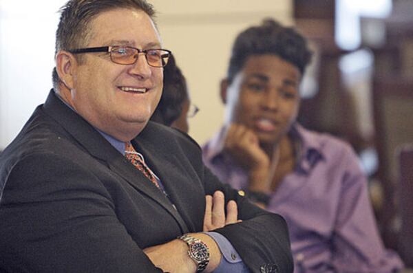 Sam Bracken sits with foster kids in his academy. When he arrived in Georgia, everything Bracken owned fit into an orange duffel bag. (Bob Andres/AJC 2020)