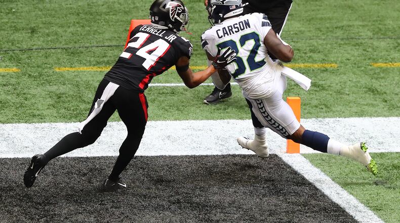Seattle Seahawks running back Chris Carson gets into the end zone past Atlanta Falcons rookie cornerback A.J. Terrell. (Curtis Compton / Curtis.Compton@ajc.com)