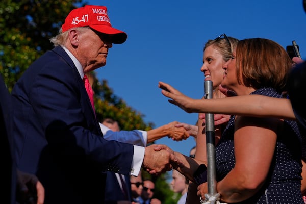 President Donald Trump and first lady Melania Trump greet guests after he signed his signature bill of tax breaks and spending cuts at the White House, Friday, July 4, 2025, in Washington. (AP Photo/Julia Demaree Nikhinson)