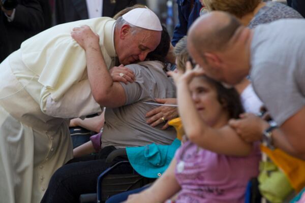 FILE - Pope Francis blesses sick and disabled people at the end of a pro-life Mass in St. Peter's Square, at the Vatican, Sunday, June 16, 2013. (AP Photo/Andrew Medichini, File)