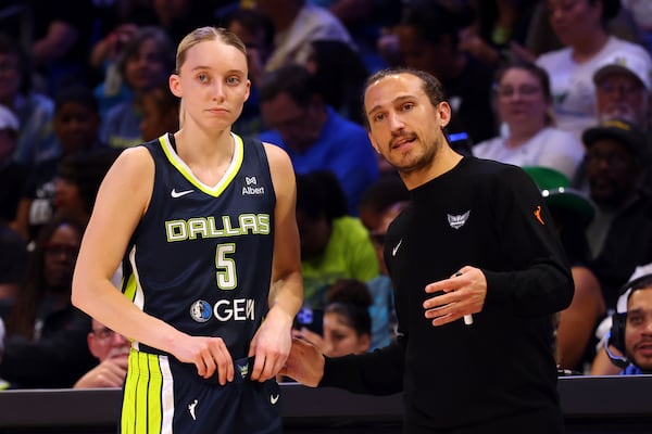 Dallas Wings guard Paige Bueckers (5) talks with head coach Chris Koclanes, right, in the first half of a WNBA basketball game against the Minnesota Lynx, Friday, May 16, 2020, in Arlington, Texas. (AP Photo/Richard W. Rodriguez)