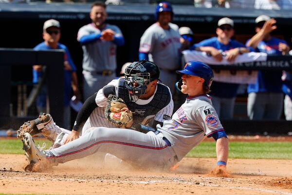 New York Mets' Brett Baty (7) reacts after being tagged out by New York Yankees catcher J.C. Escarra at home plate during the seventh inning of a baseball game, Saturday, May 17, 2025, in New York. (AP Photo/Noah K. Murray)