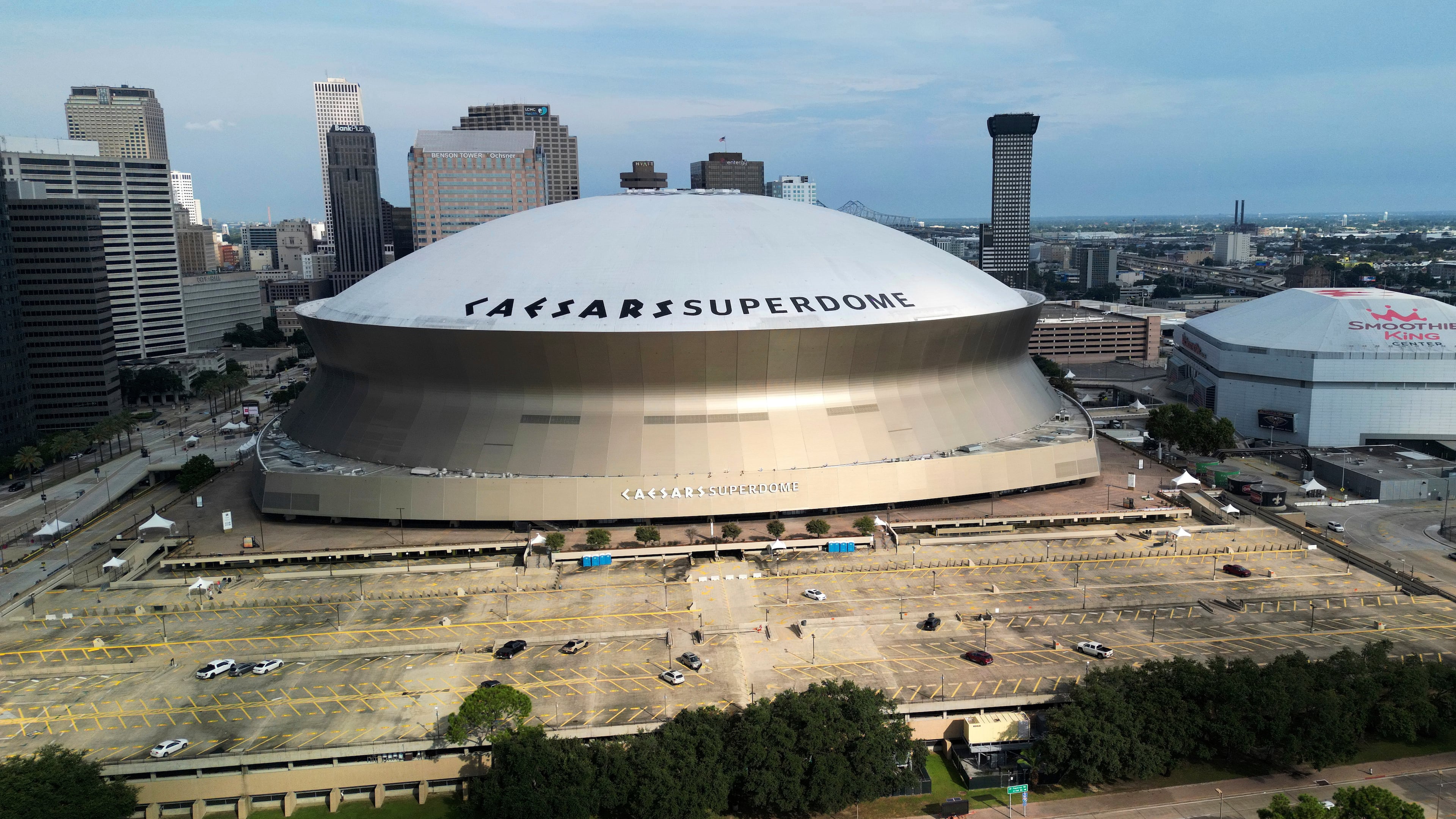 FILE - An aerial overall exterior general view of Caesars Superdome and the Smoothie King Center with the New Orleans skyline in the background is seen after an NFL preseason football game between the New Orleans Saints and the Denver Broncos in New Orleans, Saturday, Aug. 23, 2024. (AP Photo/Tyler Kaufman, file)