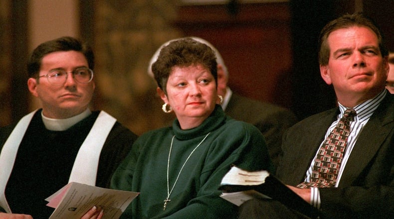Norma McCorvey, the "Jane Roe" in the 1973 Roe v. Wade decision, is flanked by The Reverend Robert L. Schenck of the National Clergy Council, left, and The Rev. Phillip Benham of Operation Rescue National during a memorial service at Georgetown University in Washington, D.C. Sunday, Jan. 21, 1996. (AP Photo/Cameron Craig)
