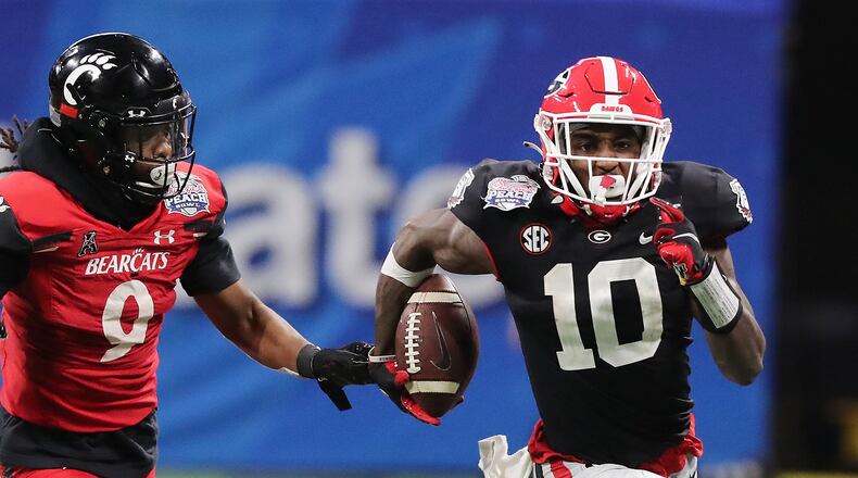 Georgia wide receiver Kearis Jackson makes a long first down gain past Cincinnati cornerback Arquon Bush during the 4th quarter in the NCAA college football Peach Bowl game on Friday, Jan. 1, 2021, in Atlanta. Curtis Compton / Curtis.Compton@ajc.com”