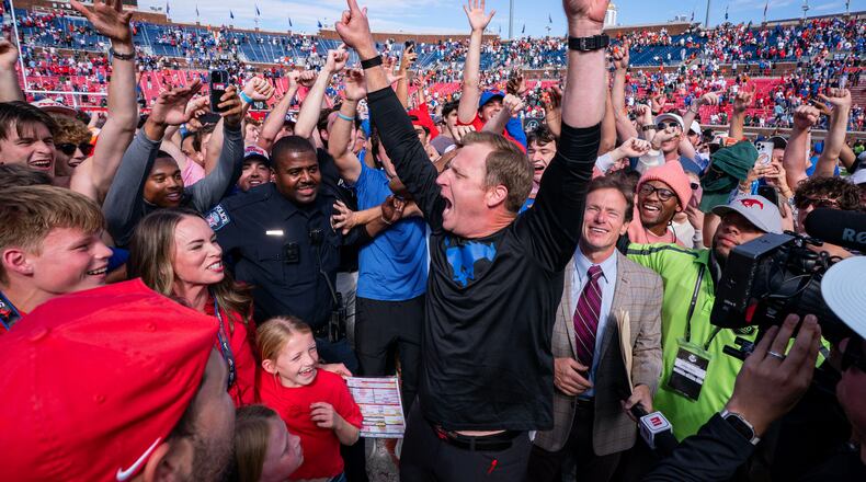 SMU head coach Rhett Lashlee celebrates on the field with fans after his team's 26-20 overtime win over Miami in an NCAA college football game, Saturday, Nov. 1, 2025, in Dallas. (AP Photo/Jeffrey McWhorter)