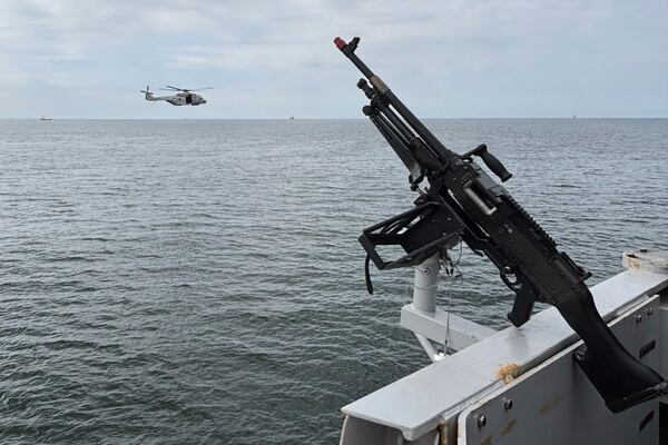 A helicopter flies by the HNLMS Tromp, a Royal Netherlands Navy guided missile frigate, patrolling on the North Sea ahead of the NATO summit in The Hague, Netherlands, Thursday, June 19, 2025. (AP Photo/Aleksandar Furtula)