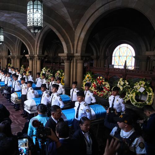 The wake for police officers killed while retaking control of three prisons is held at the Interior Ministry in Guatemala City, Monday, Jan. 19, 2026. (AP Photo/Moises Castillo)