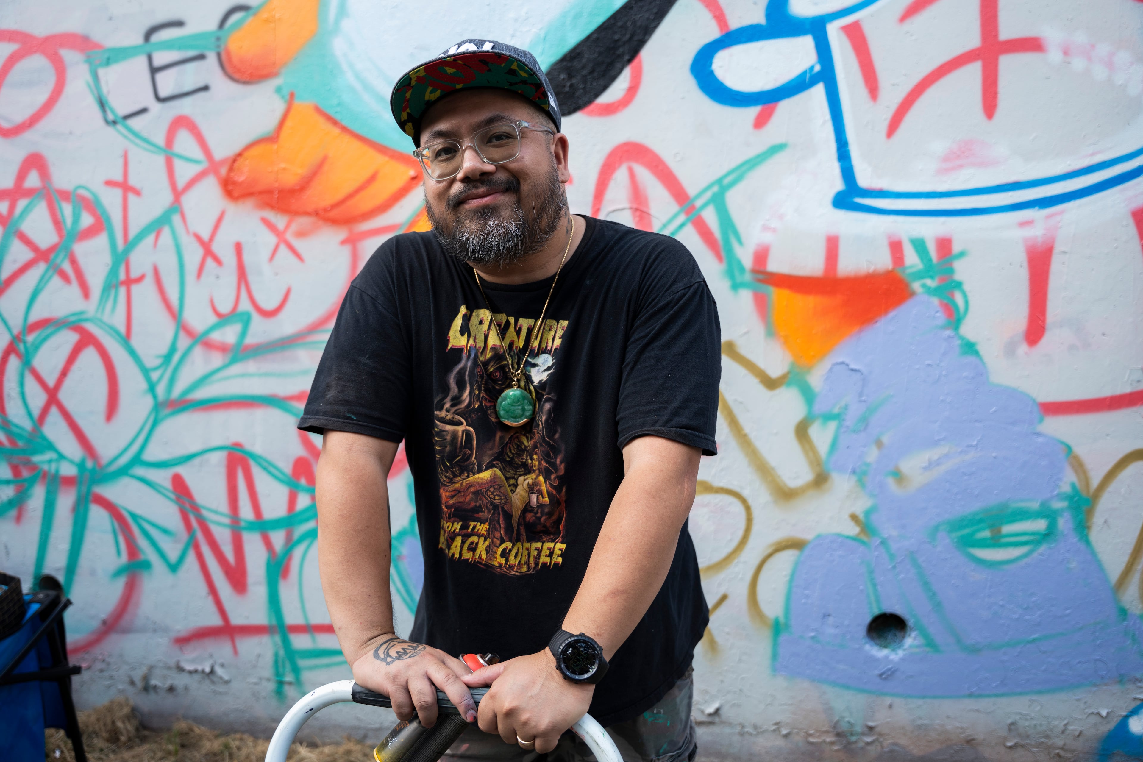 Local artist Killamari poses in front of his mural at the 11th annual Forward Warrior festival in the Cabbagetown neighborhood of Atlanta on Saturday, Sept. 13, 2025. (Olivia Bowdoin for the AJC)