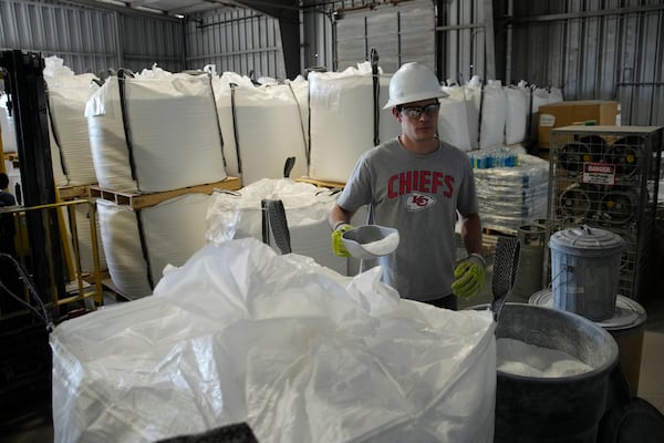 FILE - Tyler Kirkland adds a scoop to a large bag of lithium carbonate at Albemarle Corp.'s Silver Peak lithium facility, Thursday, Oct. 6, 2022, in Silver Peak, Nev. (AP Photo/John Locher, File)