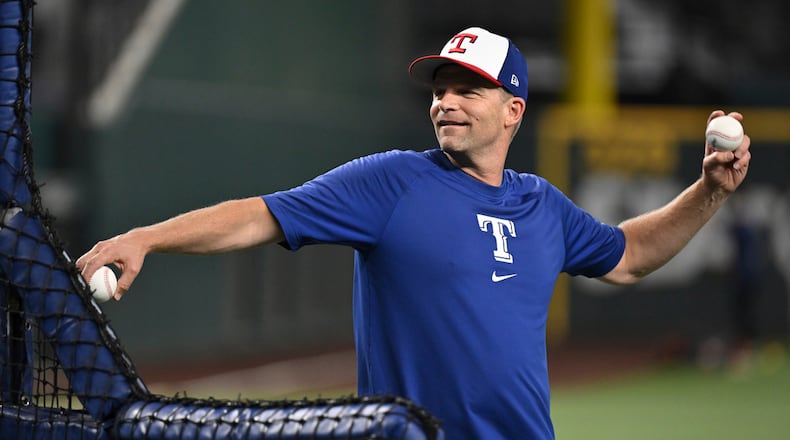 Texas Rangers coach Tim Hyers throws batting practice before a baseball game against the Houston Astros, Sunday, Aug 6, 2024, in Arlington, Texas. (AP Photo/Albert Pena)