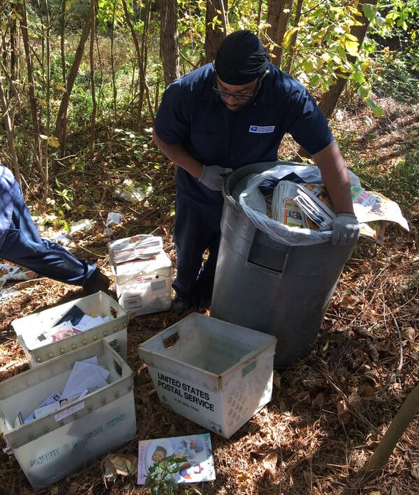 Workers delivered residents’ mail that was originally dumped. (Credit: Channel 2 Action News)