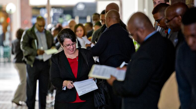 People seeking work stand in line outside a job fair in Cobb County, January 2015. (Jonathan Phillips / Special)