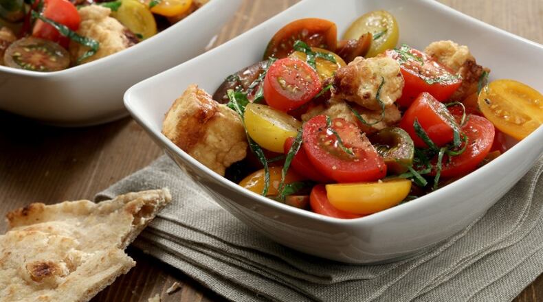 Colorful tomatoes offer a fresh, cool contrast to cubes of fried halloumi. (Michael Tercha/Chicago Tribune/TNS)