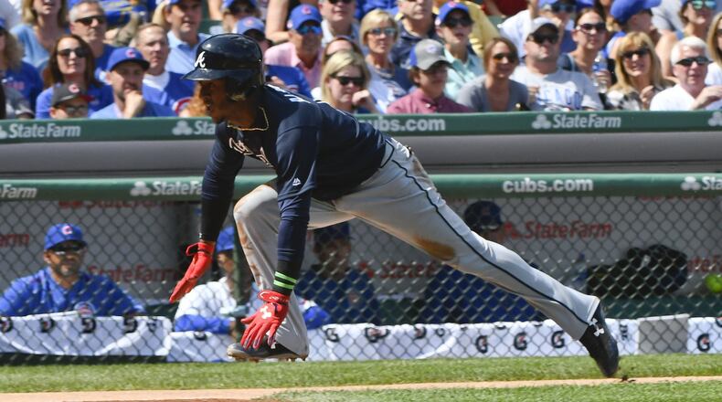 Braves’ Ozzie Albies scores during the first inning against the Chicago Cubs on Sunday, Sept. 3, 2017, in Chicago. (AP Photo/Matt Marton)