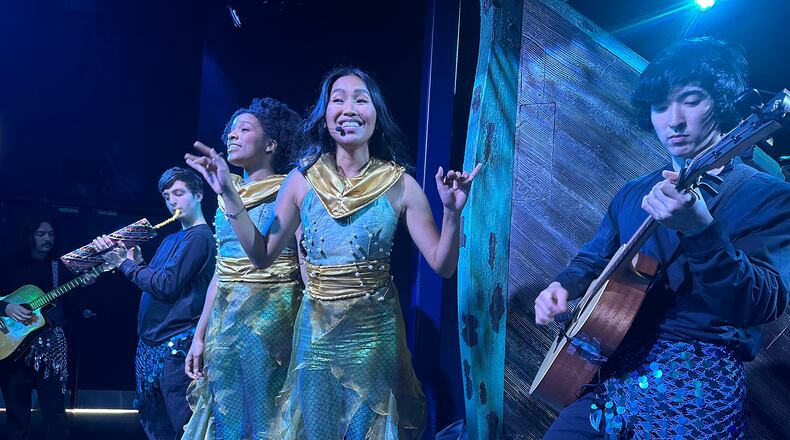 Monica Ortiz (center) sings "Under the Sea" with the rest of the musical crew of mer-persons at "The Little Mermaid" experience at CAMP in Dunwoody, during a test run on May 30, 2023, four days before official opening. RODNEY HO/rho@ajc.com