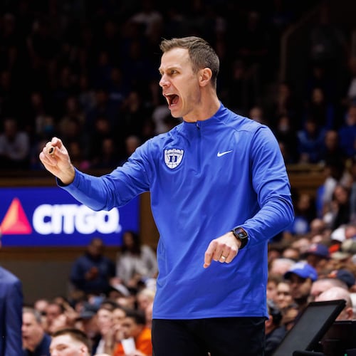 Duke head coach Jon Scheyer shouts towards the court during the second half of an NCAA college basketball game against Virginia in Durham, N.C., Saturday, Feb. 28, 2026. (AP Photo/Ben McKeown)
