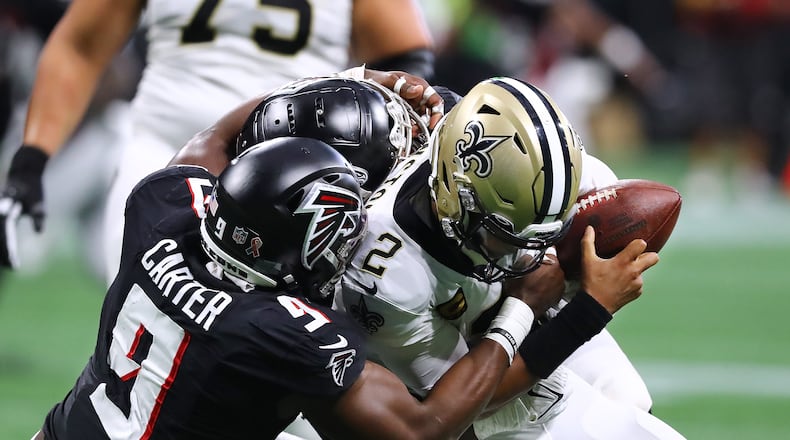 091122 Atlanta: Atlanta Falcons outside linebacker Lorenzo Carter and defensive Lineman Grady Jarrett sack Saints quarterback Jameis Winston for a loss on third down forcing a punt in the final minutes of the second quarter in a NFL football game on Sunday, Sept. 11, 2022, in Atlanta.   “Curtis Compton / Curtis Compton@ajc.com