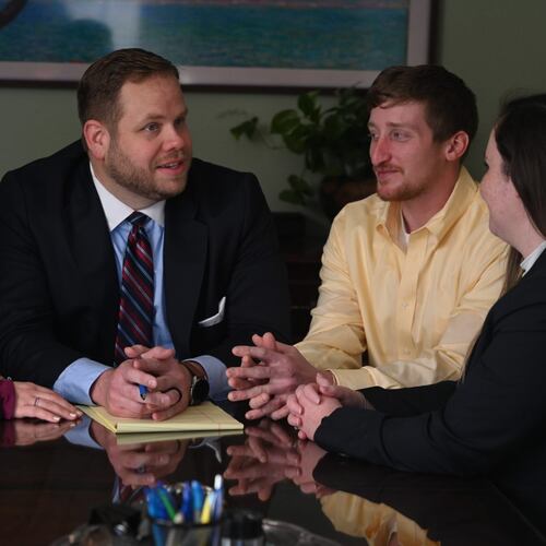 Robert Busbee (center, in this photo from his campaign) died unexpectedly on the morning of May 22. The governor named his chief assistant to run the office until an official replacement is named.