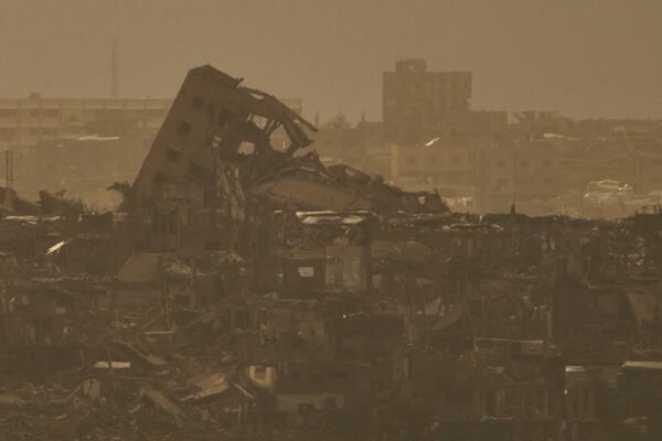 Buildings that were destroyed during the Israeli ground and air operations stand in northern of Gaza Strip as seen from southern Israel, Tuesday, April 1, 2025. (AP Photo/Leo Correa)