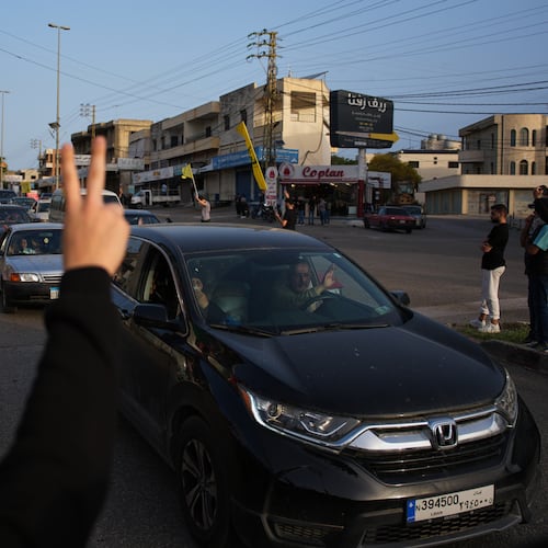 Displaced residents drive back to their villages as locals wave Hezbollah flags and an image of late Hezbollah leader Hassan Nasrallah, in Zefta, southern Lebanon, Friday, April 17, 2026, following a ceasefire between Israel and Hezbollah. (AP Photo/Hassan Ammar)