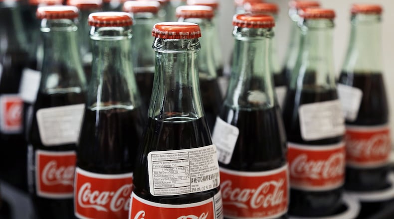 Coca Cola is spending at least $3 billion to buy Anheuser-Busch InBev’s interest African and Latin American bottlers. (AP Photo)