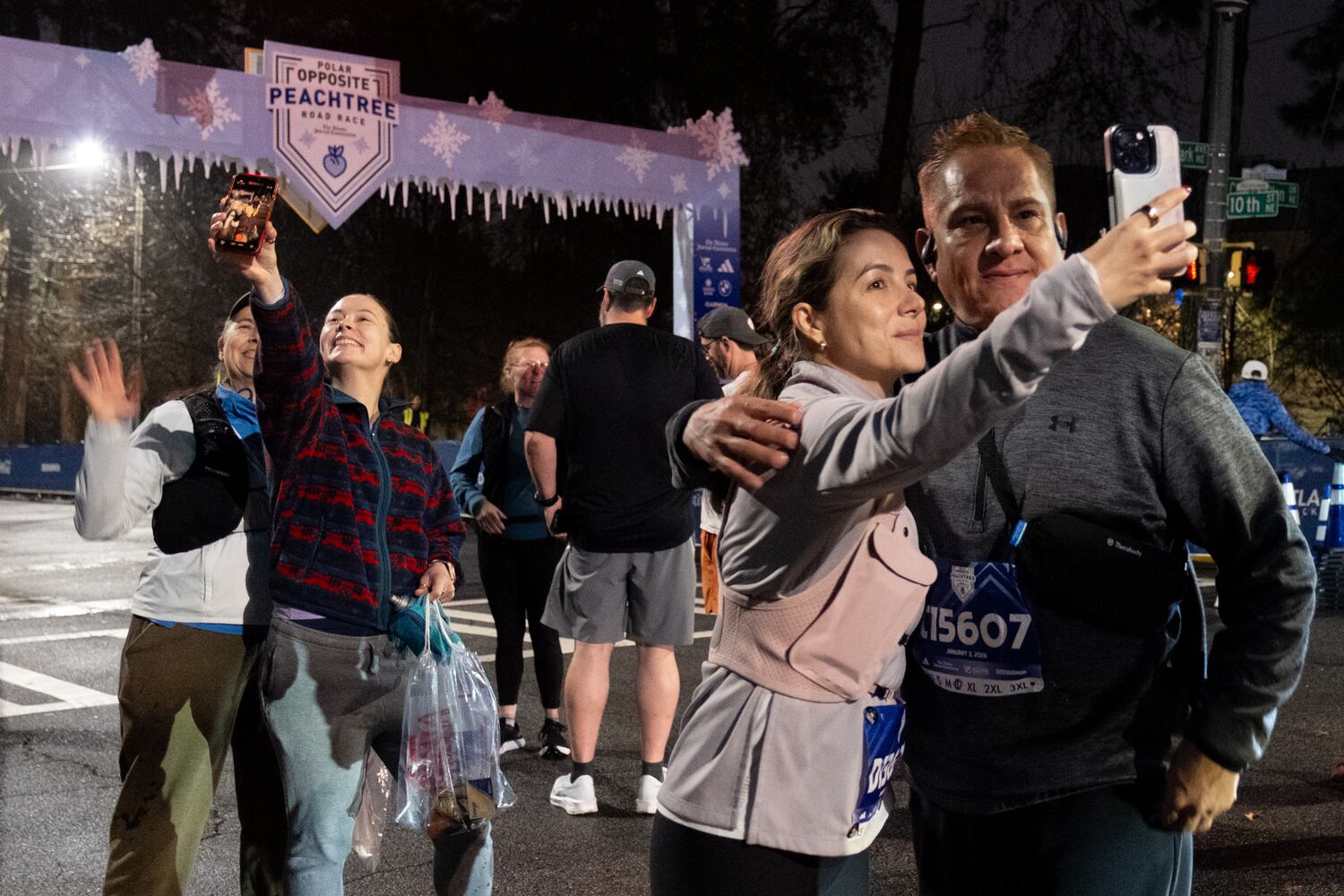 Runners pose for selfies at the start of the Polar Opposite Peachtree Road Race on Saturday, Jan. 3, 2026, in Atlanta. (Ben Gray for the AJC)