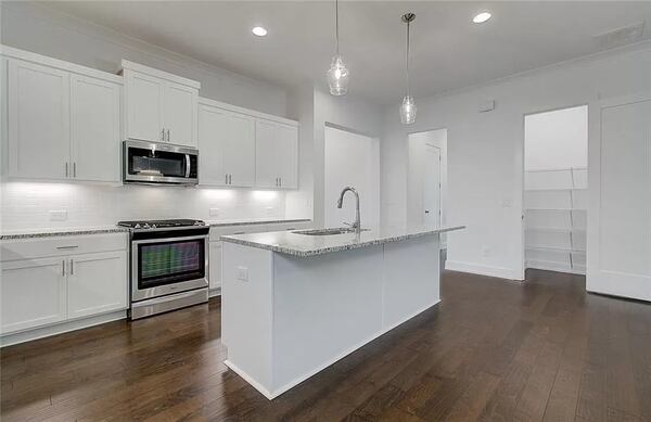Maple upper cabinets, granite countertops and stainless-steel appliances are some of the kitchen features.